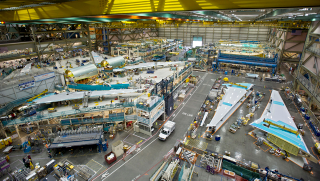 Illustration for article titled Boeing Will Dispatch Six Dumptrucks Per Minute To Build New Factory